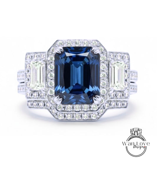 A stunning diamond engagement ring with a large blue gemstone at the center, surrounded by smaller diamonds and set in a halo of smaller diamonds.