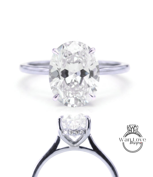 A close-up view of a diamond engagement ring with a large oval-shaped diamond set in a silver band.