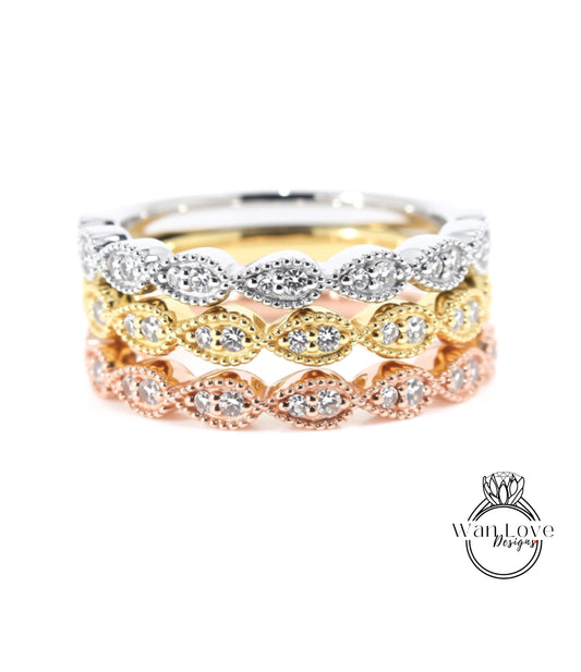 A close-up image of a ring with multiple layers of diamond-encrusted bands in various colors, including silver, gold, and peach.