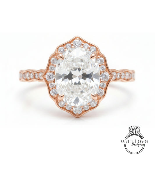 a beautiful diamond engagement ring with a large oval-shaped diamond set in a halo of smaller diamonds, all encircled by a delicate gold band.