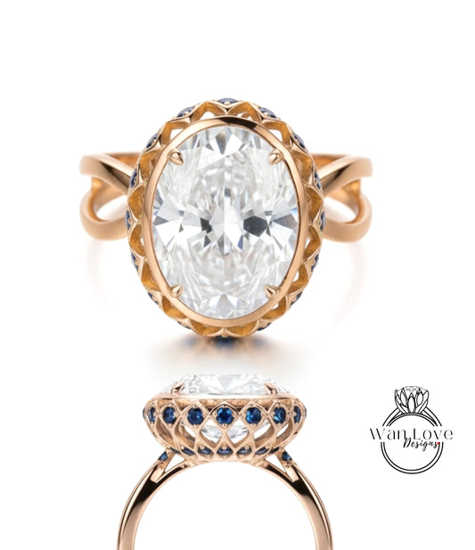 a large, oval-shaped diamond ring with a gold band and a blue and white floral design around the center stone.