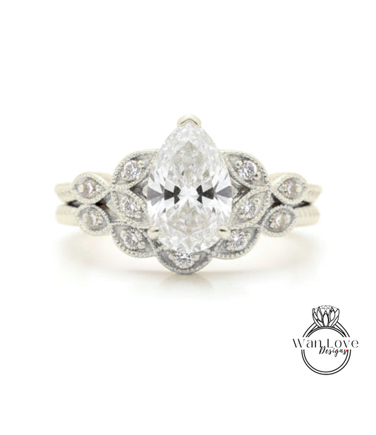 A close-up of a diamond engagement ring with a large central diamond surrounded by smaller diamonds on either side, set in a silver band.