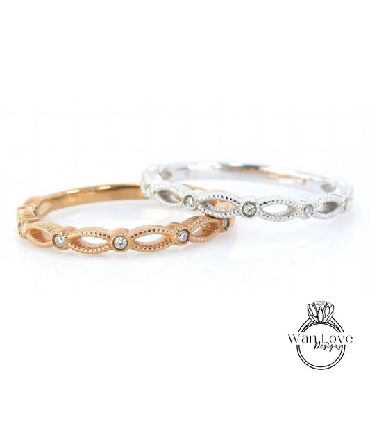 Two rings with diamonds set in a decorative pattern, one in gold and one in silver.