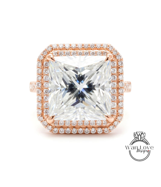 A large, square diamond ring with a halo of smaller diamonds around the edges, set in a rose gold band.