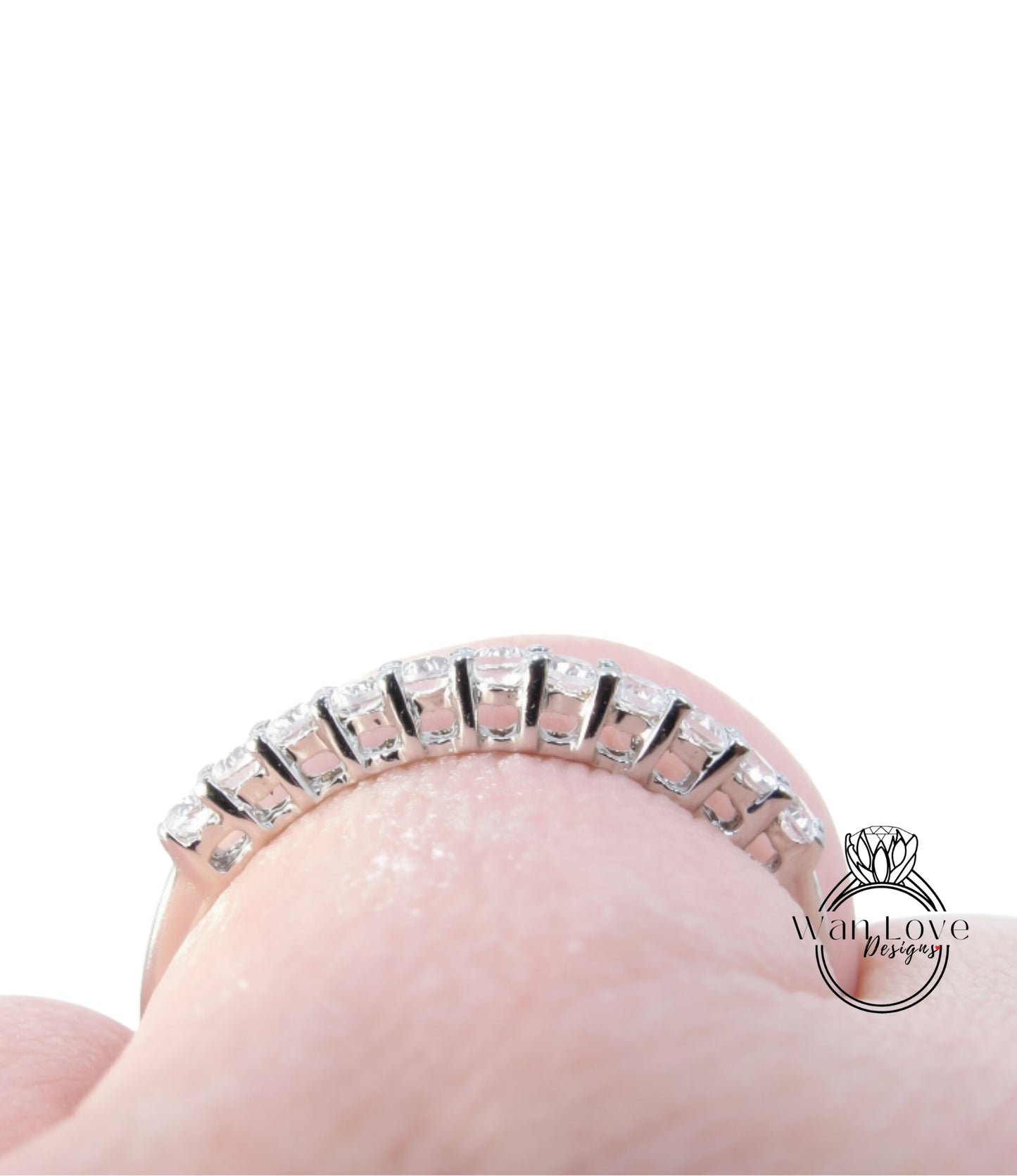 A close-up view of a diamond ring on a person's finger, showcasing the intricate design and sparkling diamonds.