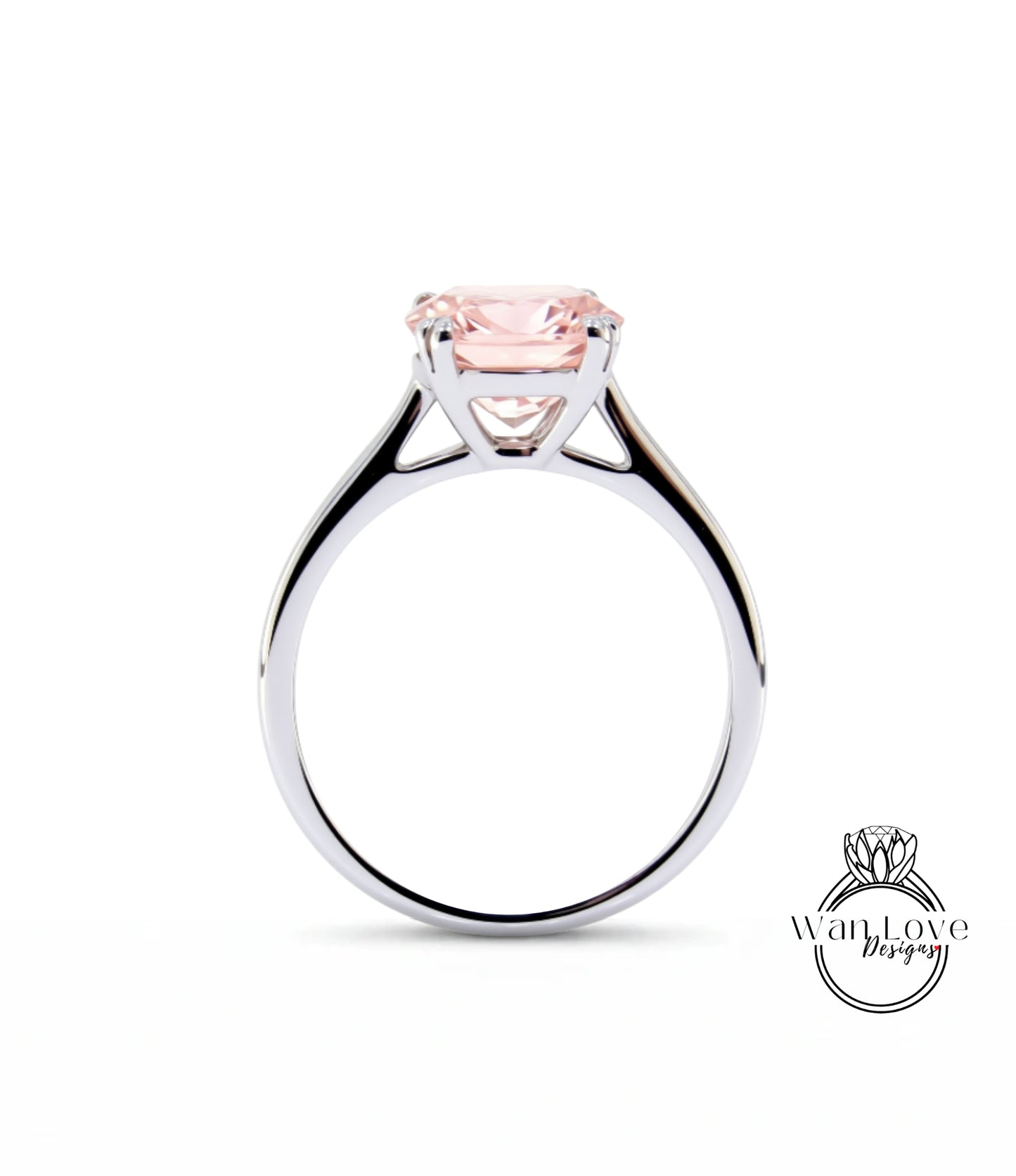 A silver engagement ring with a large pink gemstone set in the center.