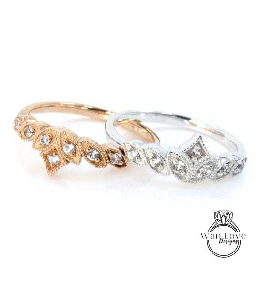 Two rings with intricate designs and sparkling gemstones are displayed against a white background.