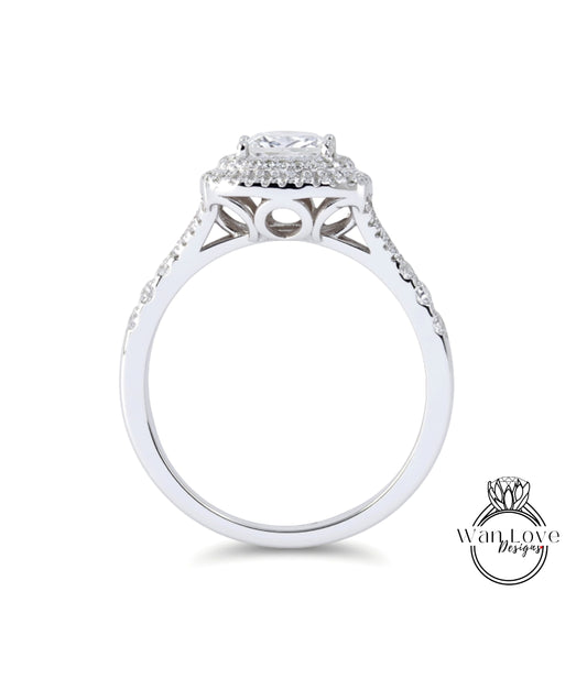 A silver engagement ring with a large central diamond surrounded by smaller diamonds, set in a halo of smaller diamonds.