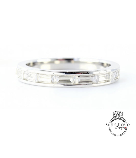 A silver band ring with a row of small diamonds set in it.