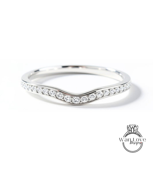 A silver ring with a curved band and a row of small diamonds set in it.