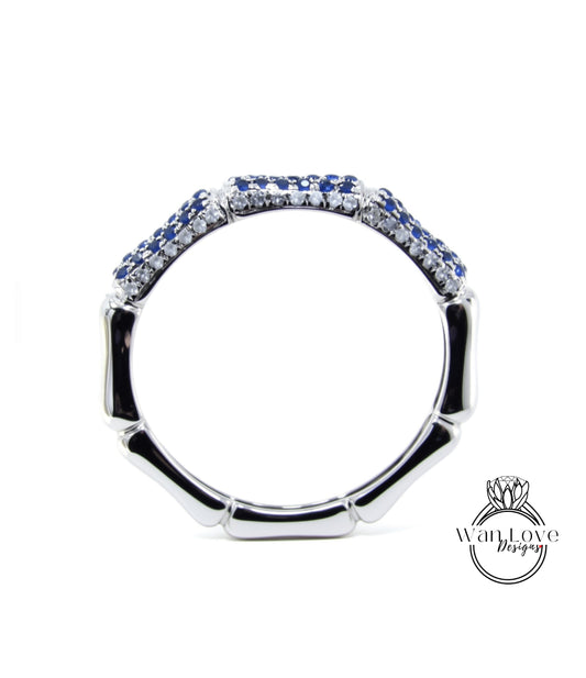 A silver ring with blue gemstones, including sapphires, set in a decorative pattern.