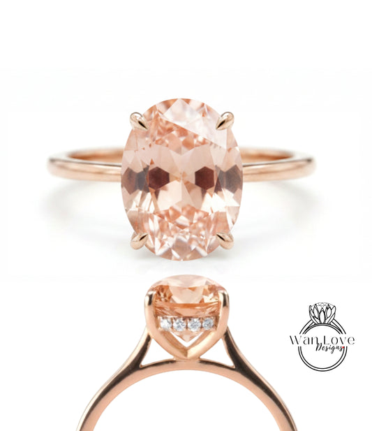 a rose gold ring with a large oval-shaped gemstone set in the center.