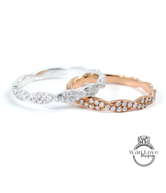Two rings with diamonds on them are placed side by side against a white background.