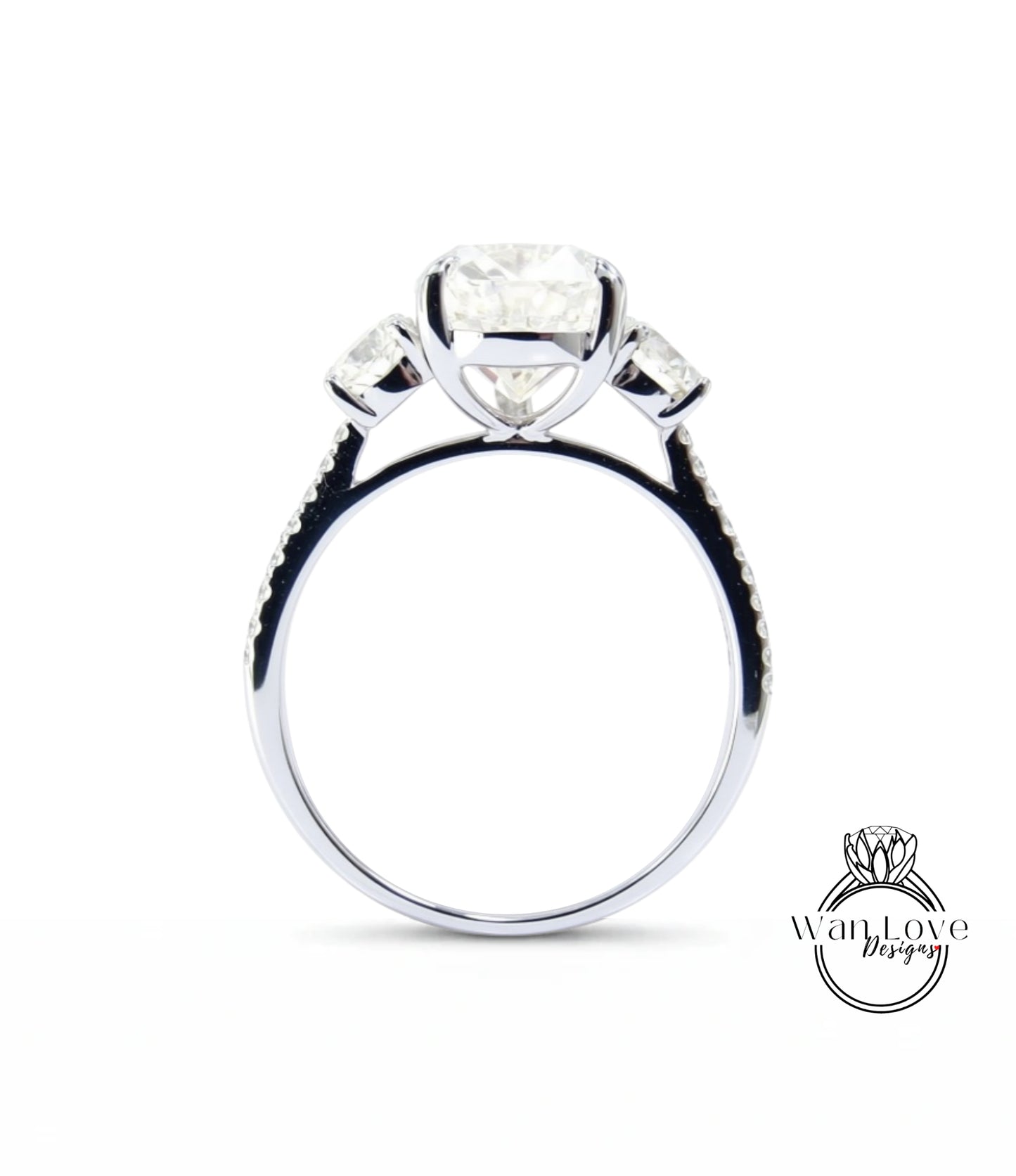 A silver engagement ring with a large central diamond and three smaller diamonds on either side.