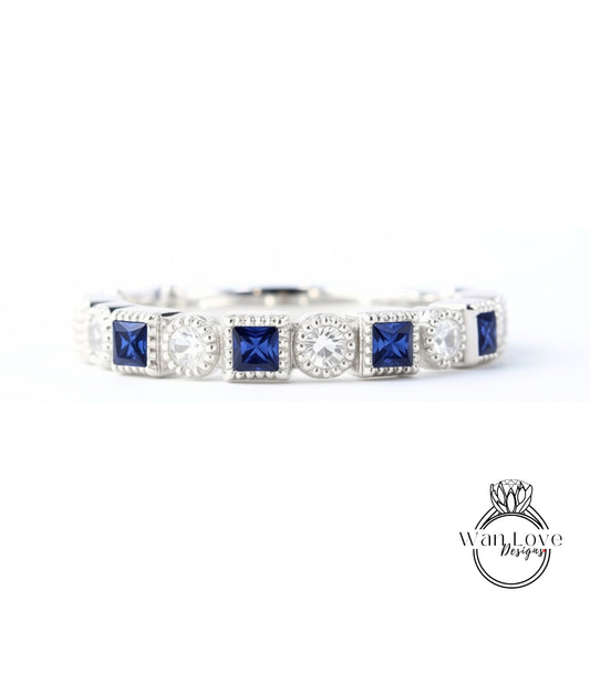 A silver and blue diamond-encrusted bracelet with square-shaped blue gemstones.