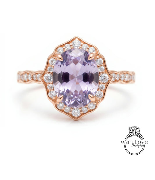 a beautiful ring with a large oval-shaped purple gemstone surrounded by a halo of smaller diamonds.