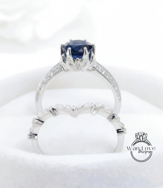 A close-up view of a silver ring with a large blue gemstone, showcasing the intricate design and craftsmanship of the jewelry piece.