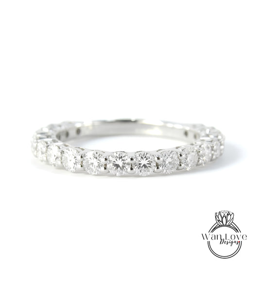A diamond-encrusted ring with a row of round diamonds set in a silver band.