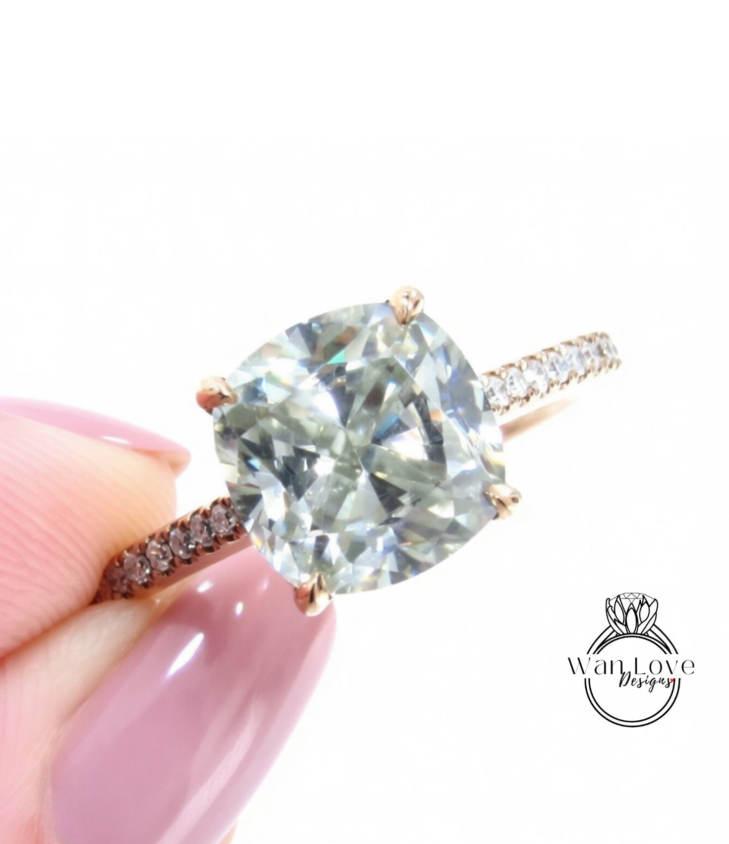 A close-up image of a person's hand holding a diamond engagement ring with a large, clear gemstone set in a gold band.