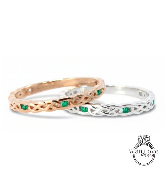 Two rings with intricate designs and green gemstones are displayed against a white background.