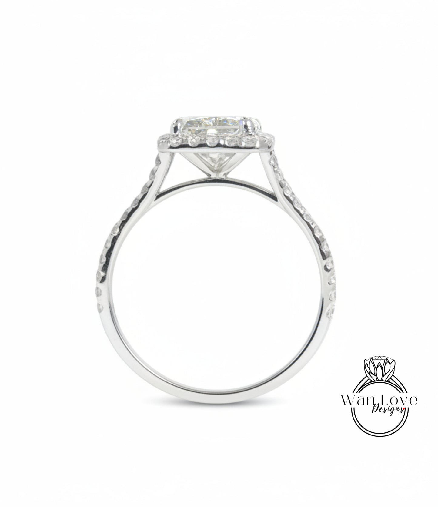A silver engagement ring with a large central diamond and a halo of smaller diamonds around the center stone.