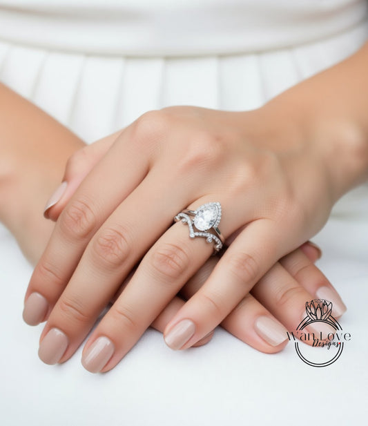 A close-up of a person's hands wearing a diamond engagement ring.