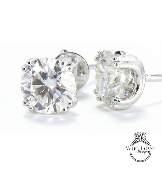 A pair of elegant earrings with large, clear diamonds set in a silver metal frame.