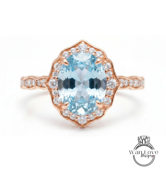 A beautiful ring featuring a large oval-shaped blue gemstone surrounded by a halo of smaller diamonds set in a rose gold band.