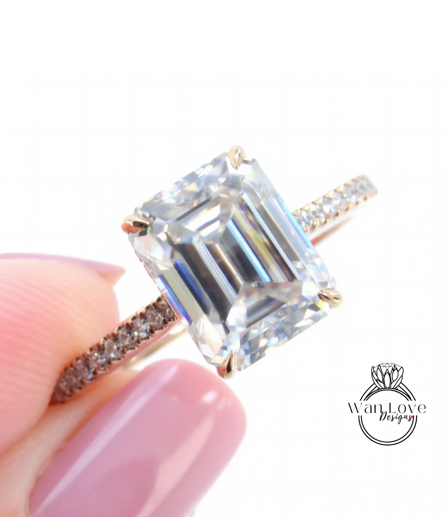 A close-up of a diamond engagement ring being held by a person's hand, showcasing the large, clear gemstone set in a gold band.