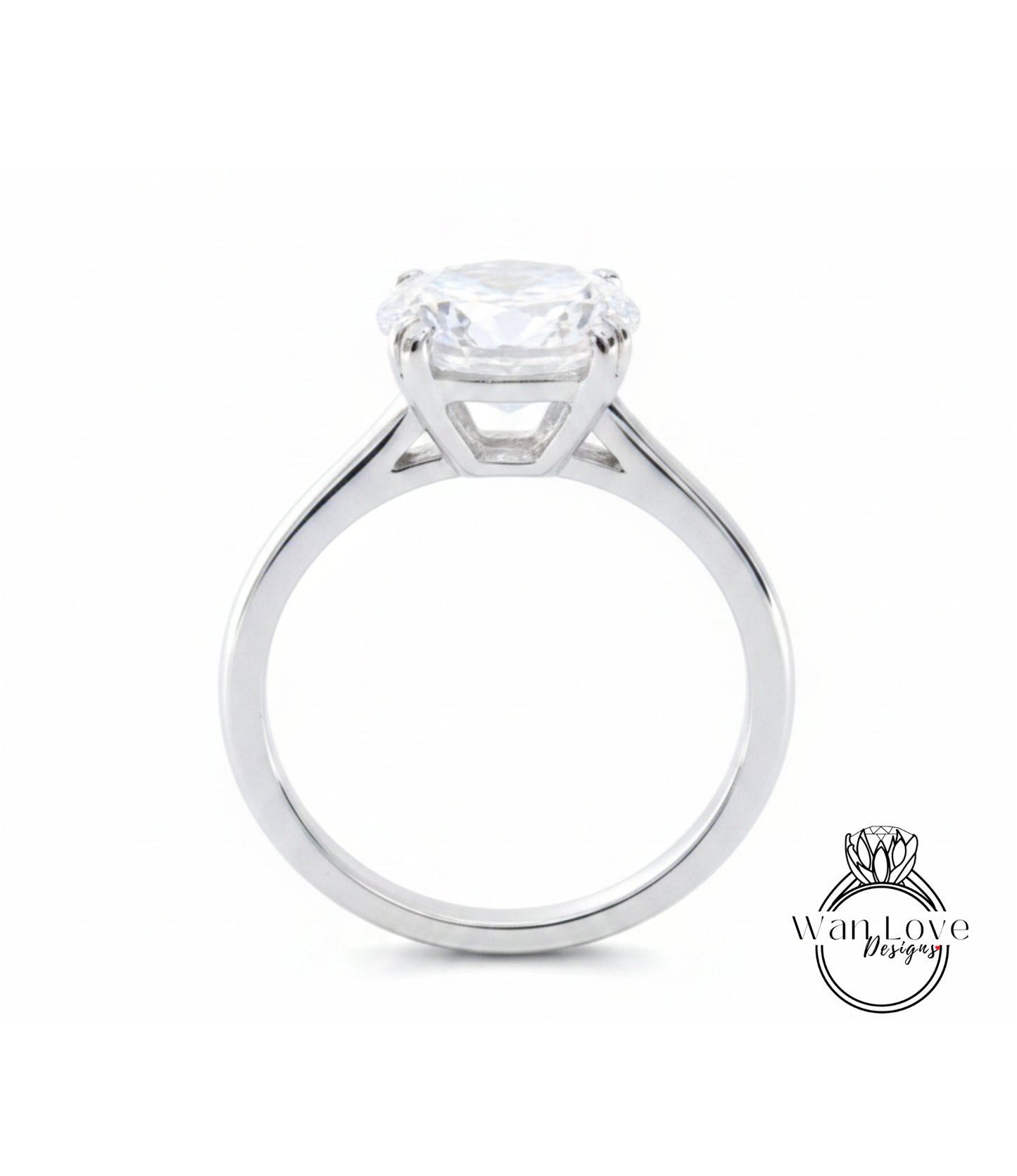 A silver engagement ring with a large, clear gemstone set in the center of the band.