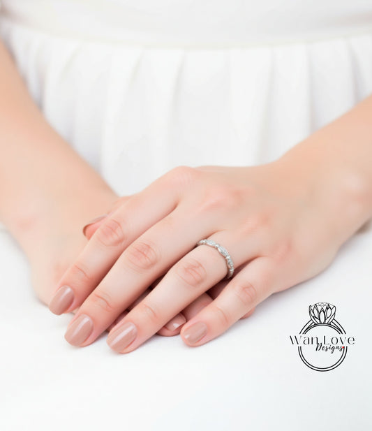 A close-up of a person's hands wearing a ring, with a focus on the ring and the person's fingers.