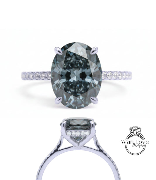 A close-up view of a silver engagement ring with a large oval-shaped diamond as the centerpiece.
