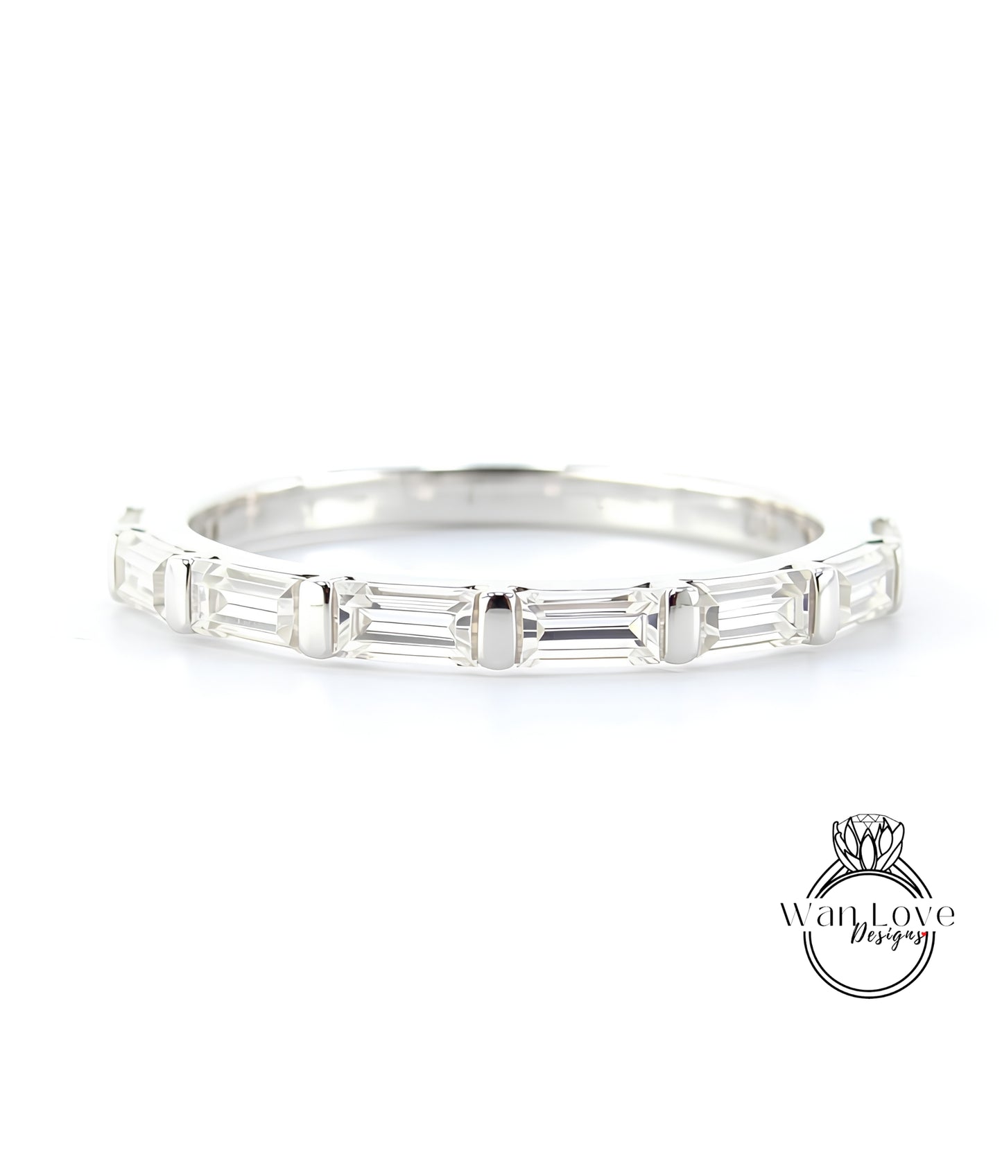 A silver band with a row of clear gemstones, likely diamonds, set in a simple yet elegant design.
