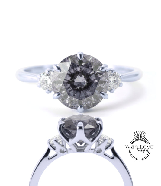 A close-up view of a silver engagement ring with a large oval-shaped diamond as the centerpiece, surrounded by smaller diamonds.