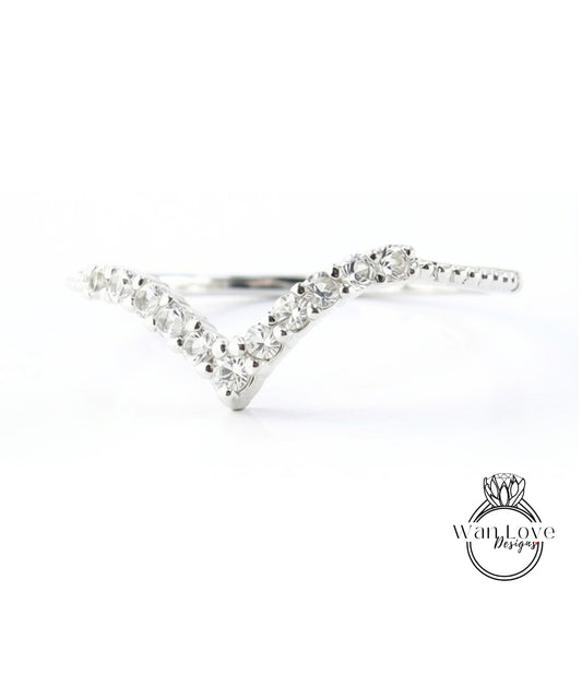 A silver ring with a v-shaped design and small diamonds set in it.