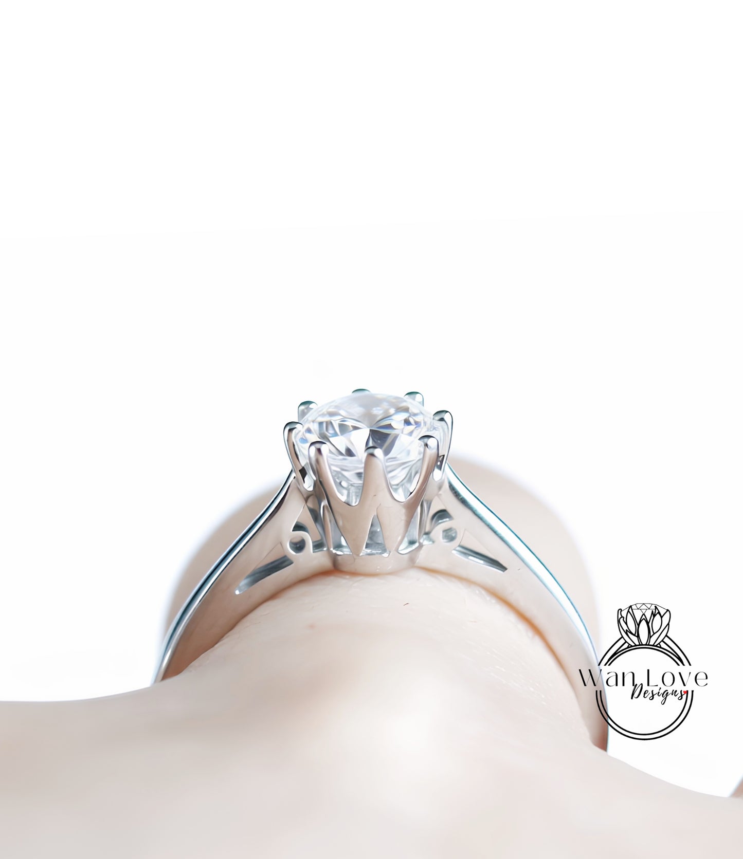 A close-up view of a diamond engagement ring on a person's hand, showcasing the intricate design and sparkling center stone.
