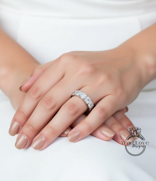 A close-up of a person's hands wearing a large, ornate ring on the ring finger.