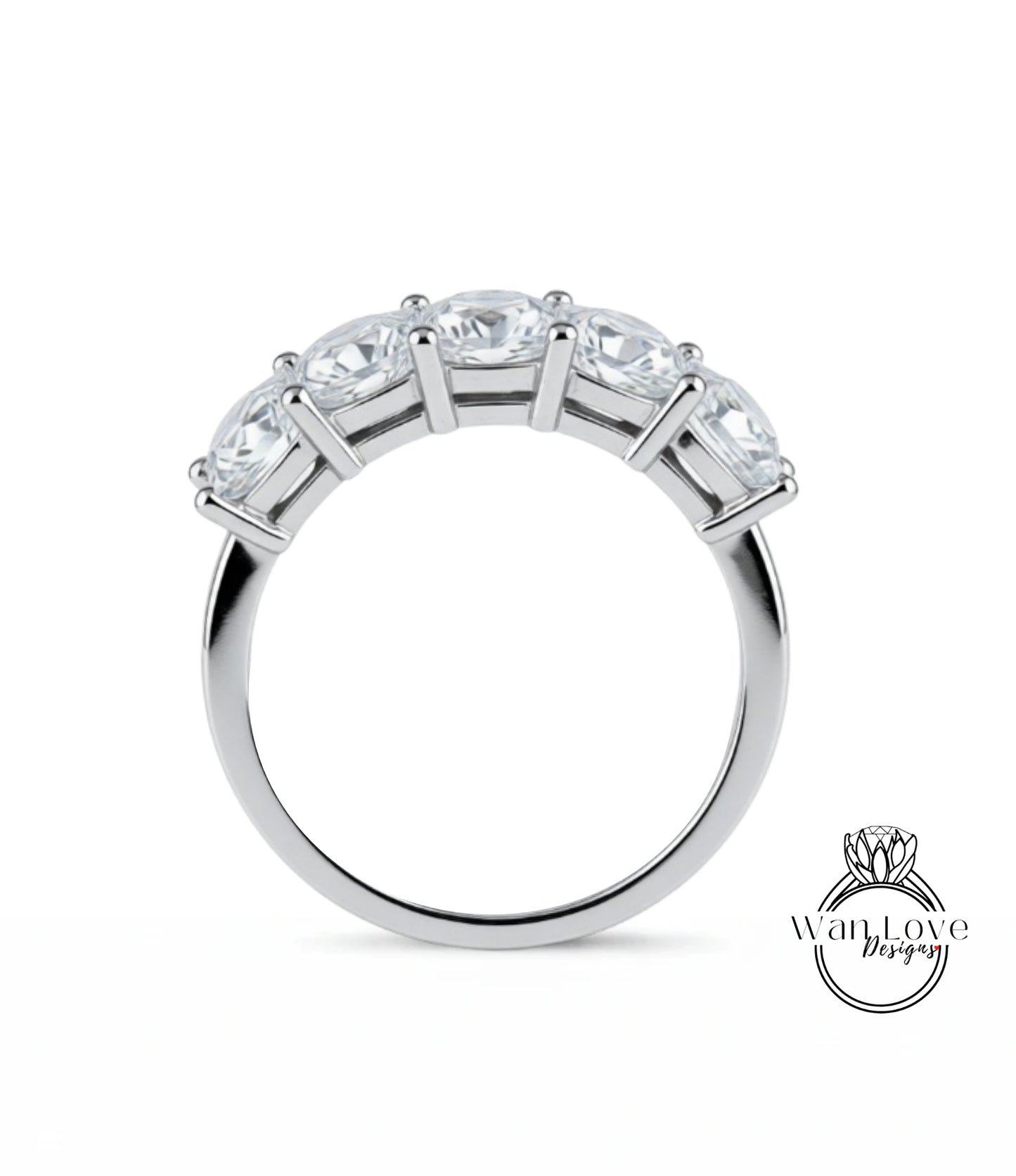 A silver ring with a row of five clear gemstones set in the band.