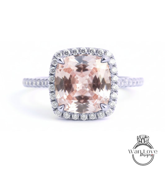 A large, pink gemstone ring with a halo of smaller diamonds around the center stone.