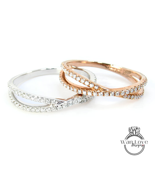 Two rings with diamonds set in a cross-over design, one silver and one gold.