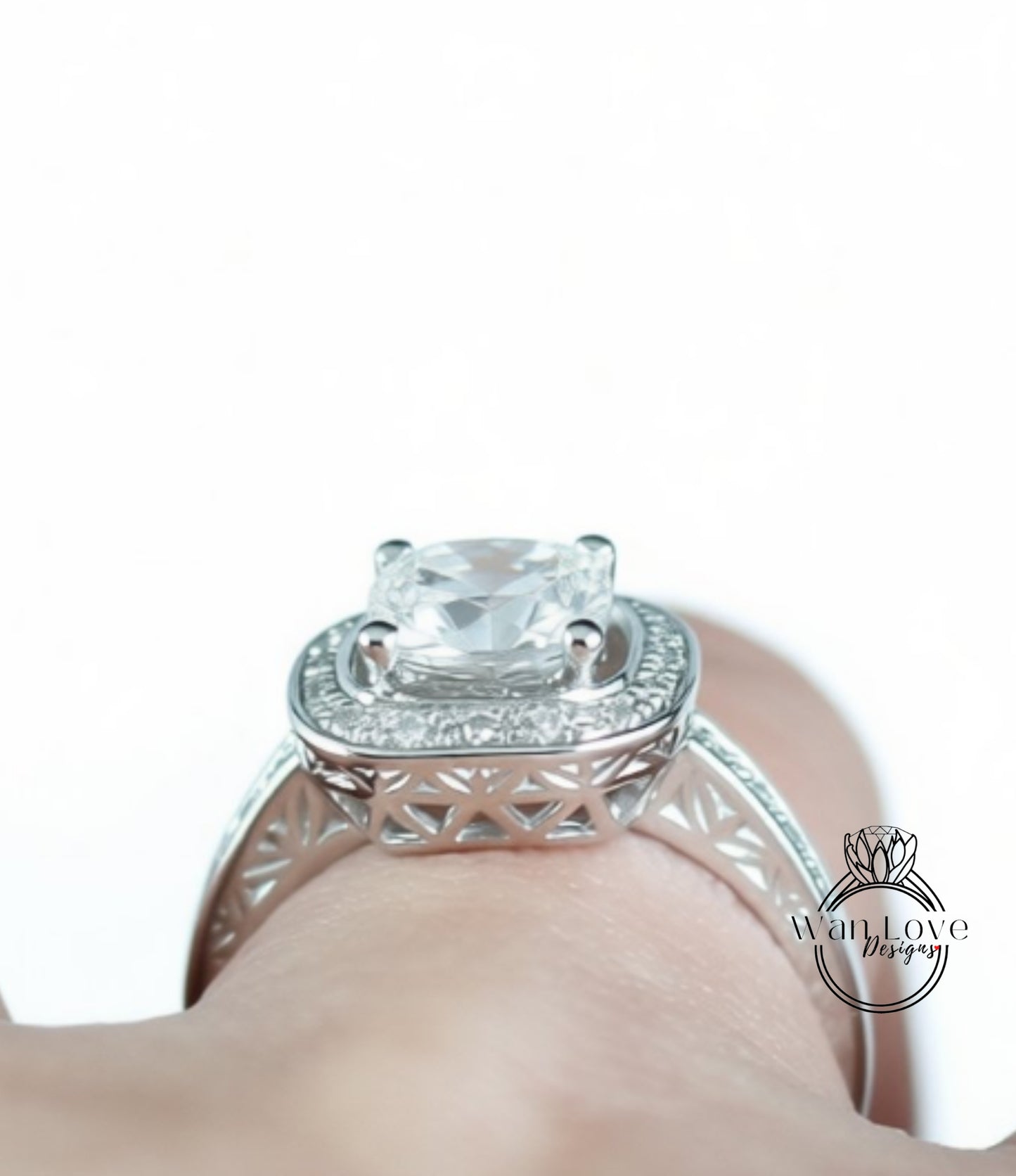 A close-up view of a diamond engagement ring on a person's hand.
