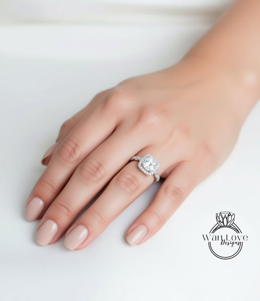 A close-up of a hand wearing a diamond engagement ring.