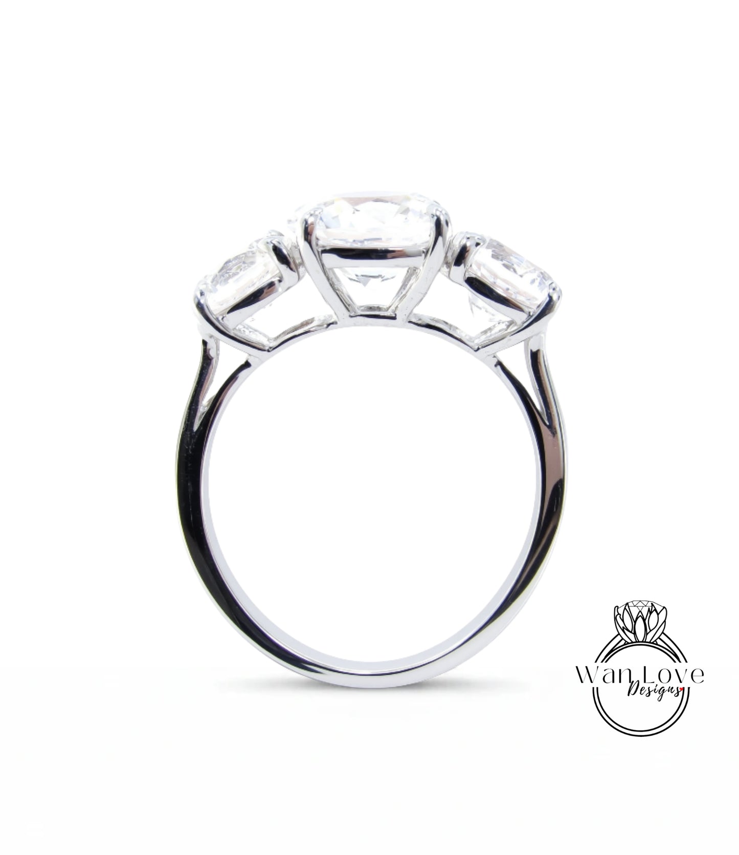 A silver ring with three large diamonds set in the center.