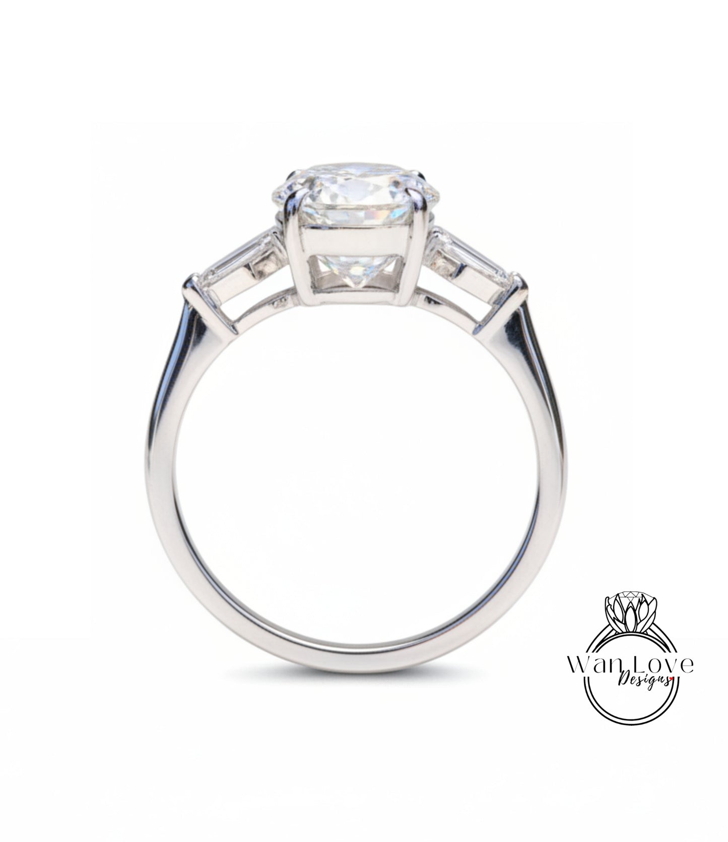 A close-up of a silver engagement ring with a large central diamond and two smaller diamonds on either side.