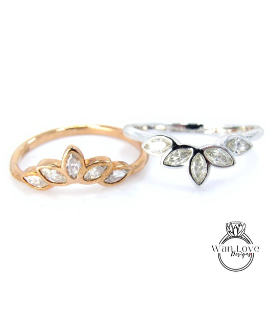 Two rings with different designs, one with a floral pattern and the other with a leaf-like pattern, both featuring small diamonds.