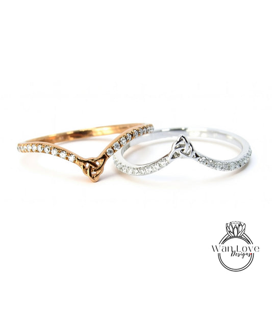 Two rings with diamonds on them are placed side by side against a white background.