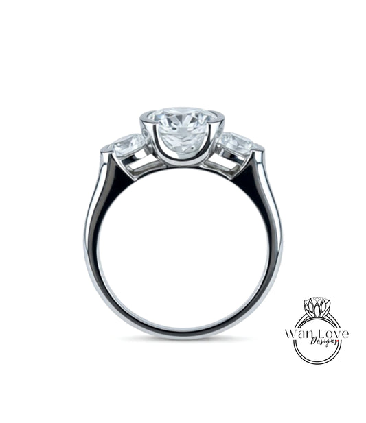 A silver ring with a large central diamond and three smaller diamonds on either side.