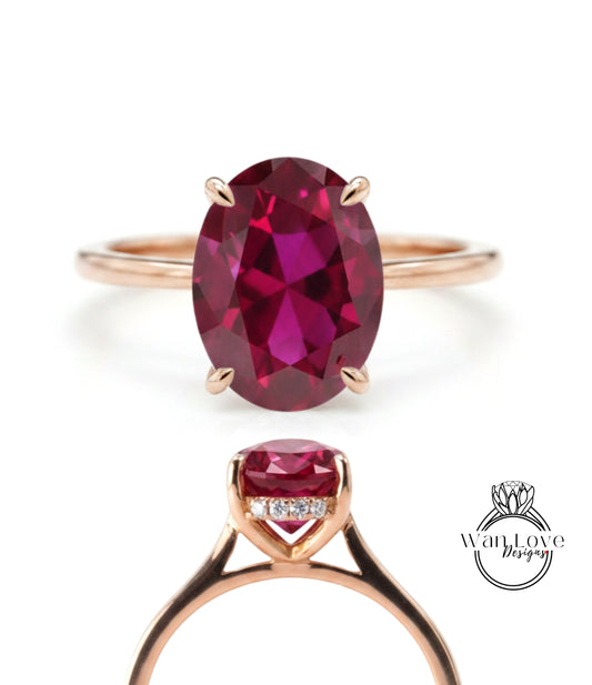 a gold ring with a large oval-shaped gemstone, which appears to be a deep red gemstone.