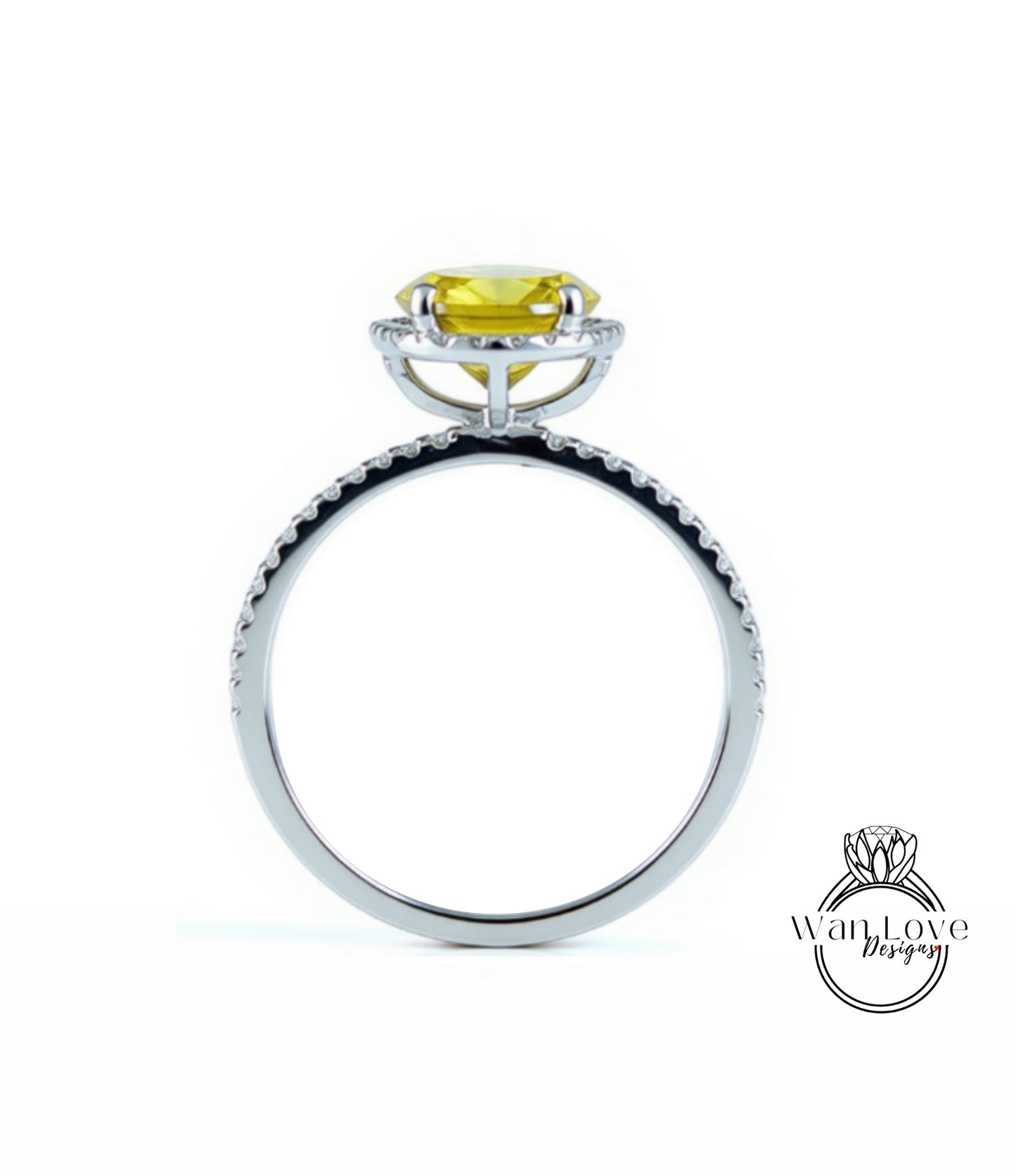 A silver ring with a yellow gemstone, possibly a diamond, set in the center.