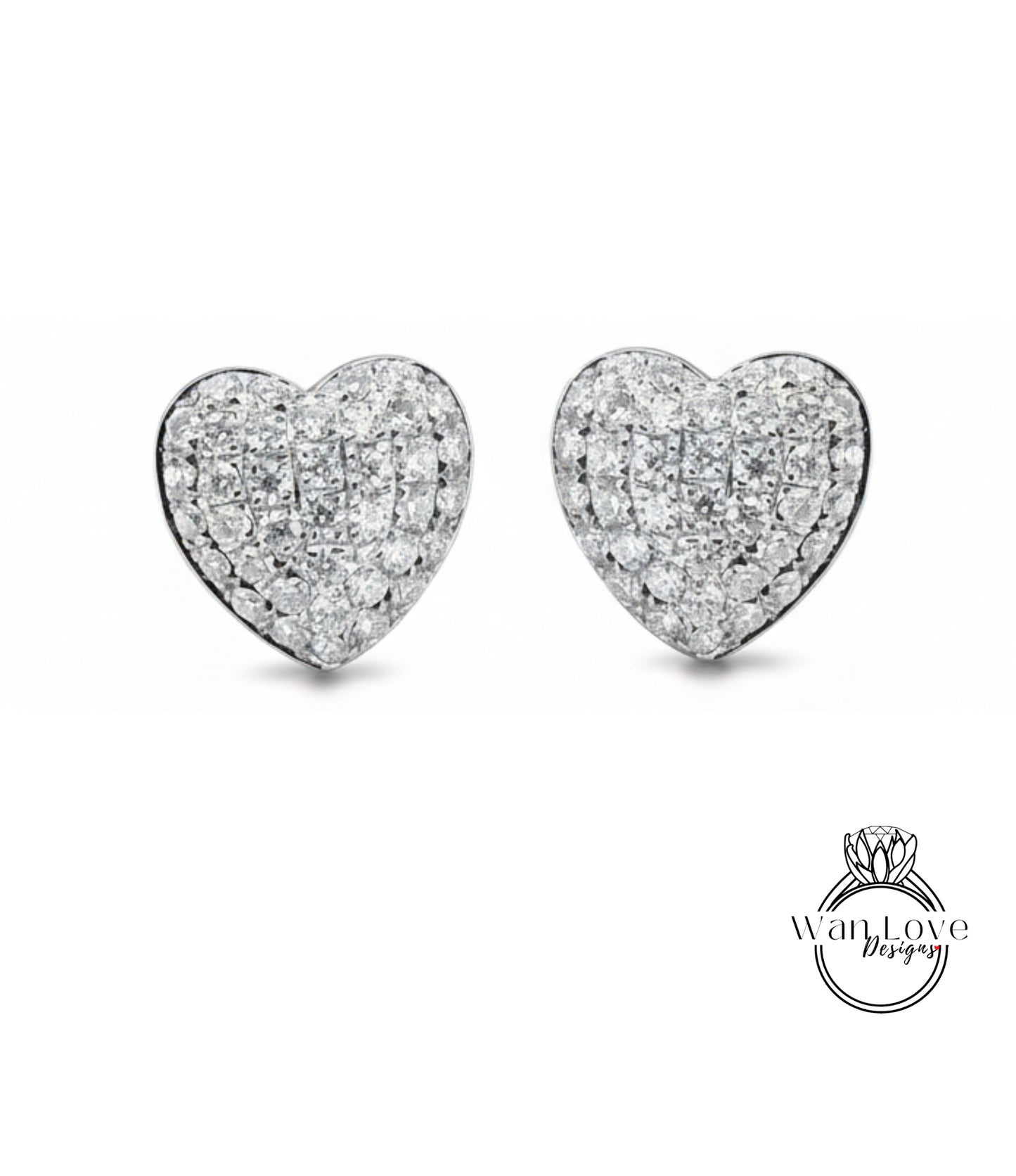 A pair of elegant diamond-encrusted heart-shaped earrings against a white background.